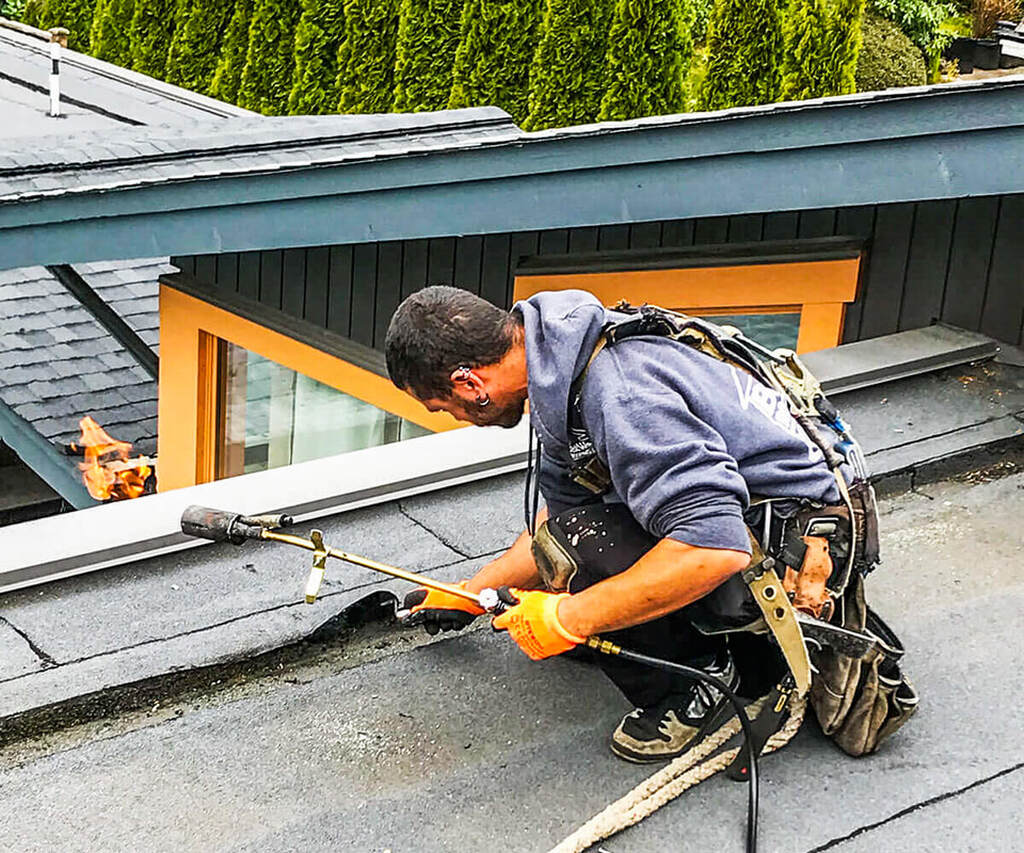 A man is Repairing on the roof